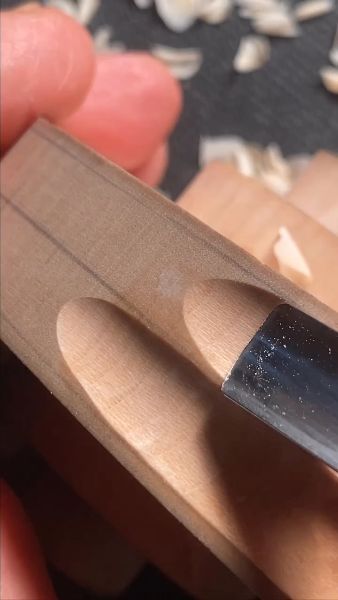 Carving the fluting on a cello scroll